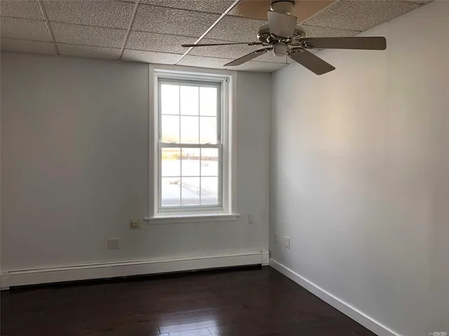 a view of a small space with wooden floor and windows