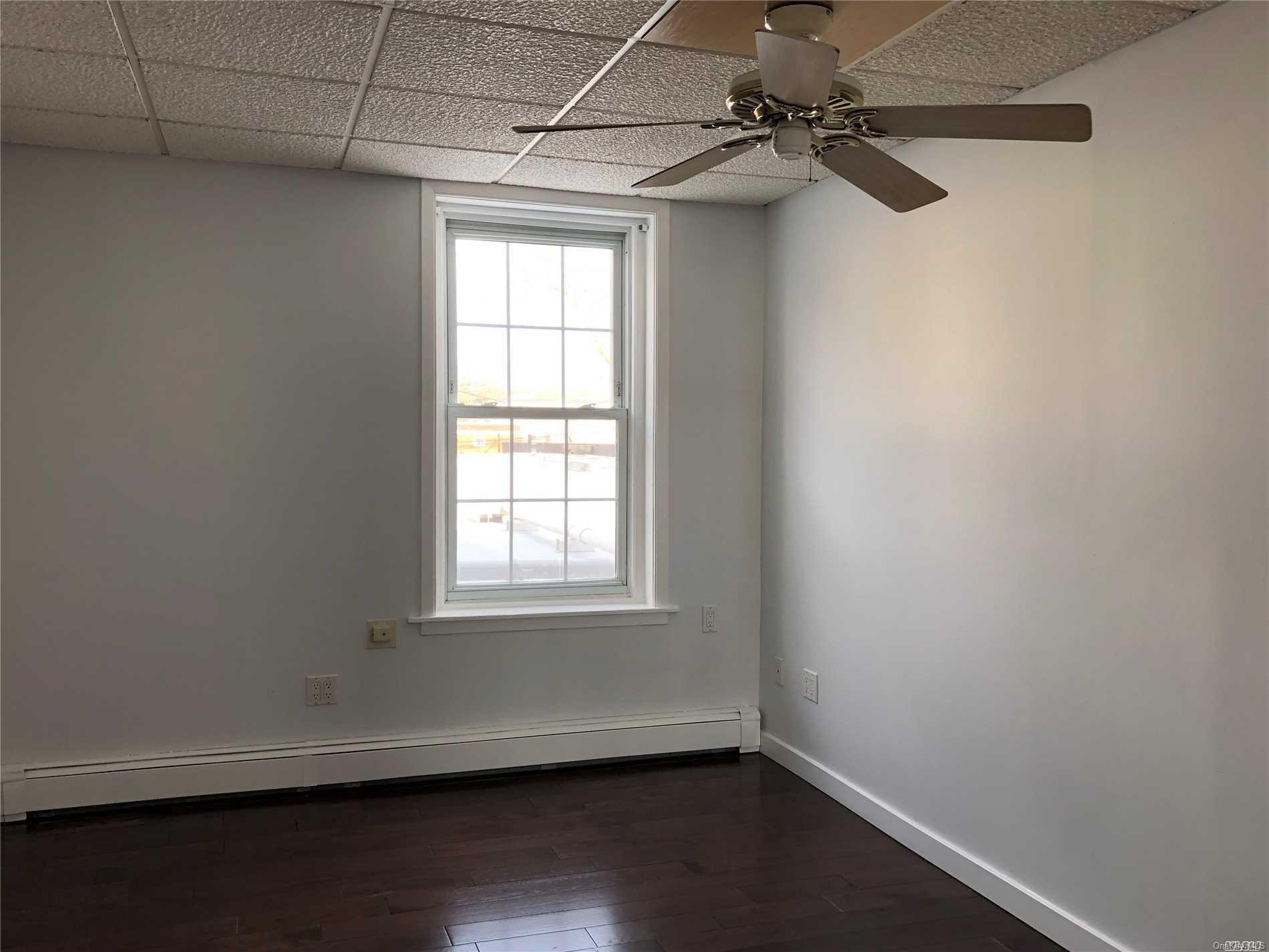 7 Green Street, Unit 2F Huntington, NY 11743 - Photo 4 of 8 a view of a room with wooden floor and windows