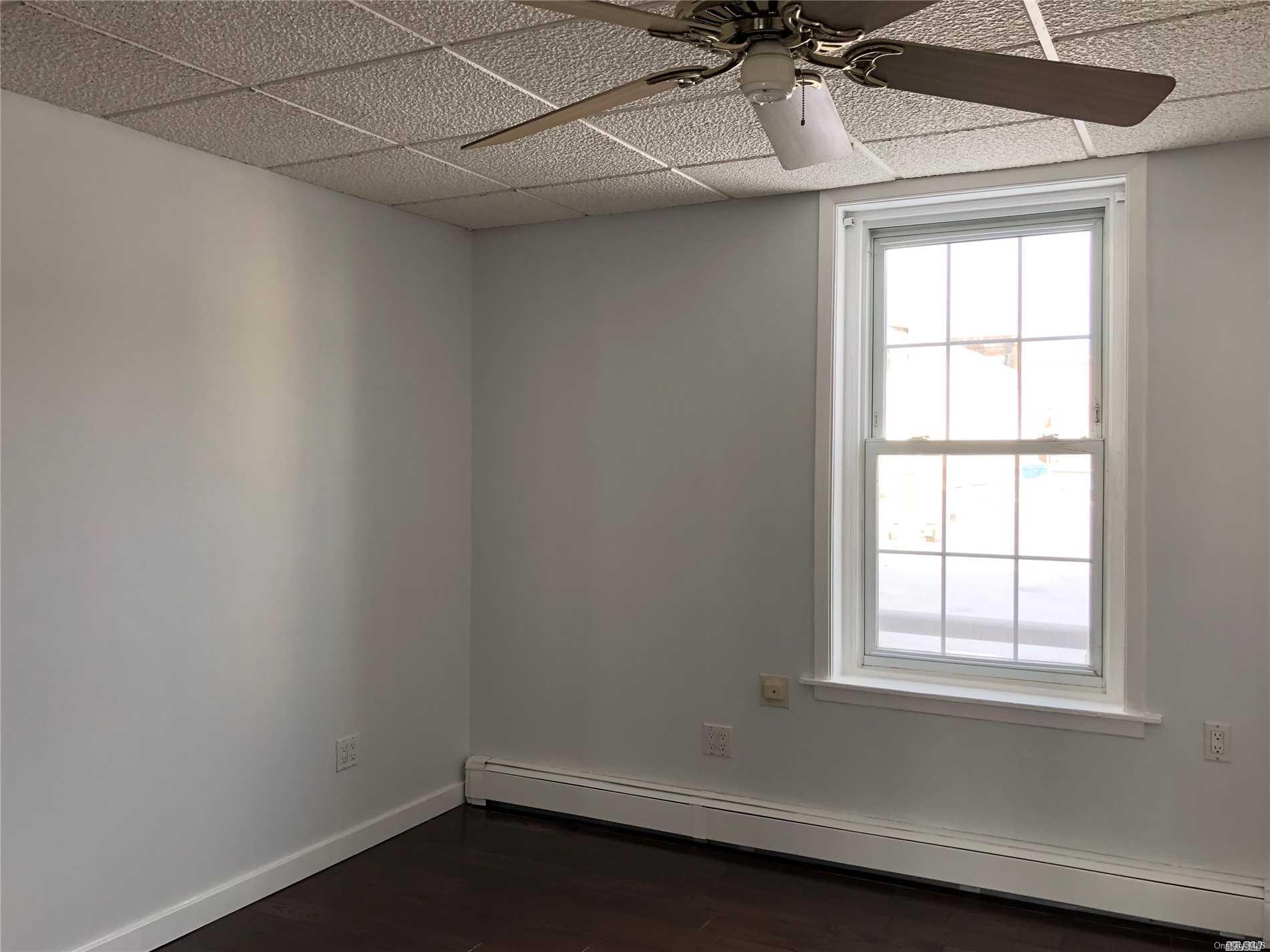 7 Green Street, Unit 2F Huntington, NY 11743 - Photo 5 of 8 an empty room with a window and a fan