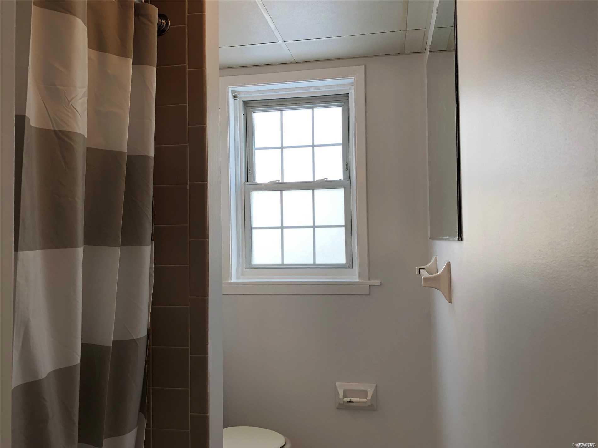 7 Green Street, Unit 2F Huntington, NY 11743 - Photo 6 of 8 a bathroom with a window