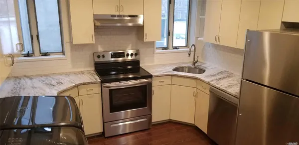 a kitchen with appliances and cabinets