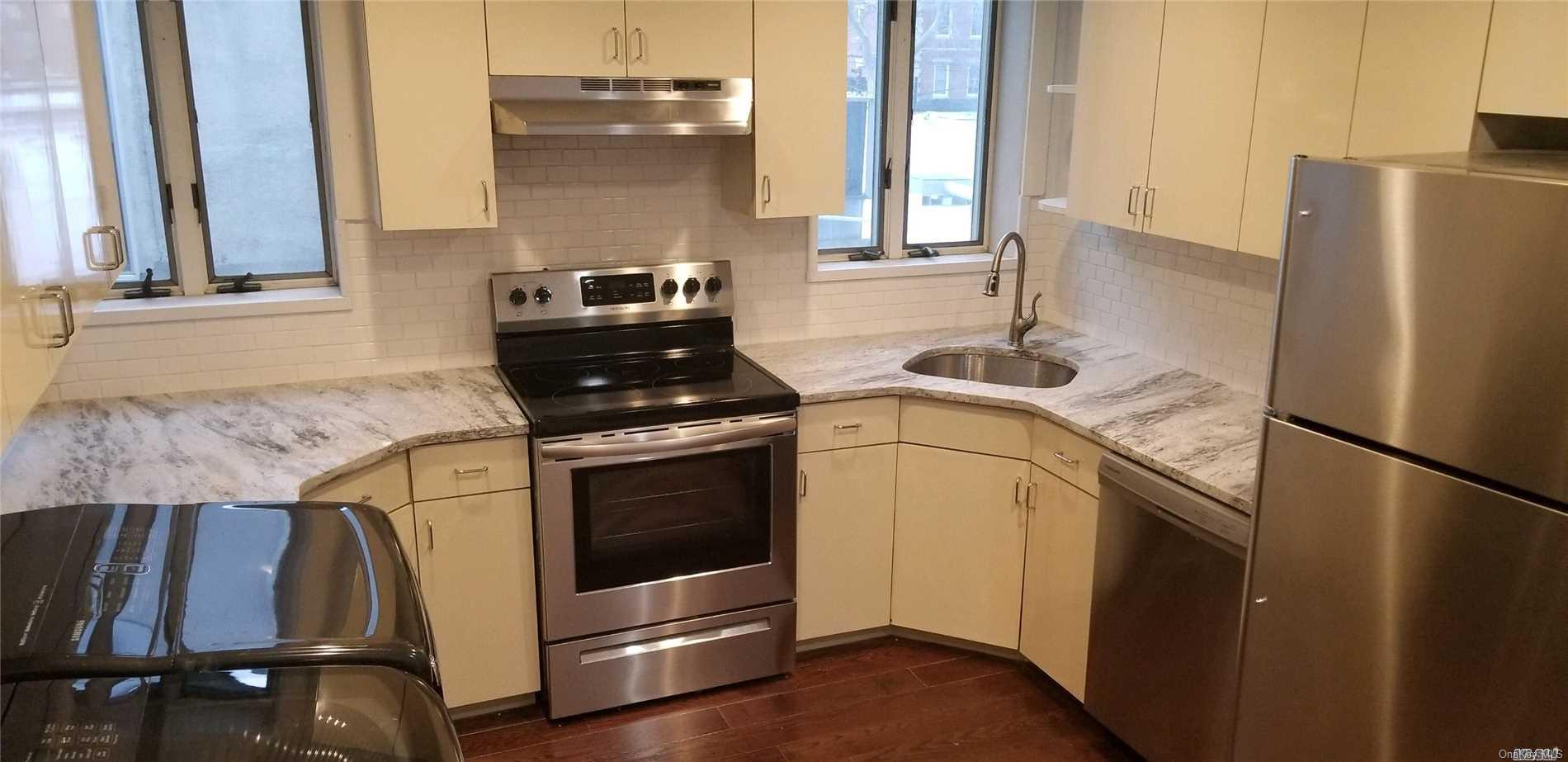 7 Green Street, Unit 2F Huntington, NY 11743 - Photo 7 of 8 a kitchen with appliances and cabinets