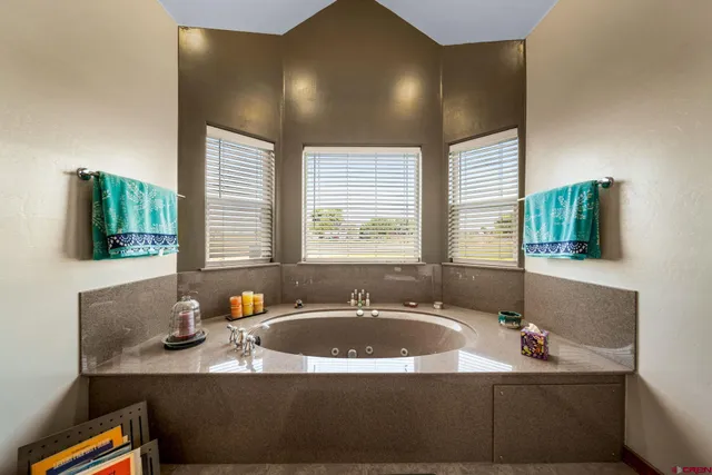 a bathroom with a granite countertop sink and a large mirror
