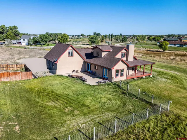 an aerial view of a house with a big yard