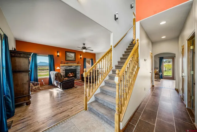 a hallway with wooden floor and furniture