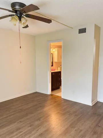 a bathroom with a granite countertop shower a toilet and a sink