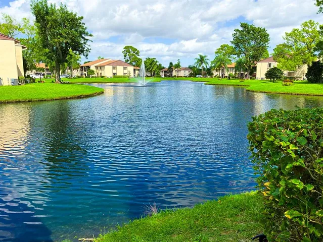 a view of a lake with a house in the background