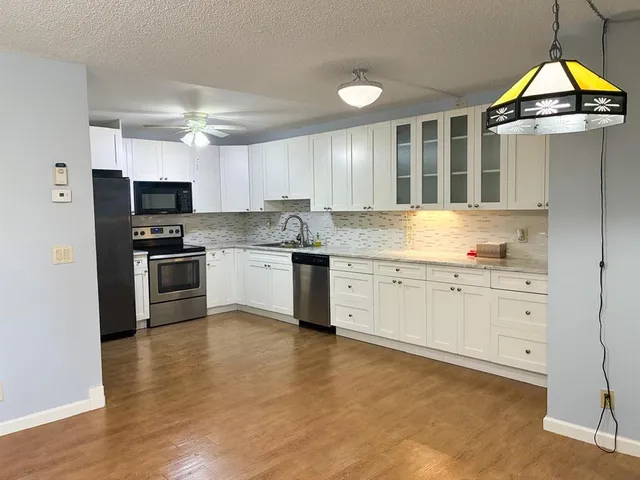 a kitchen with stainless steel appliances granite countertop a stove and a sink