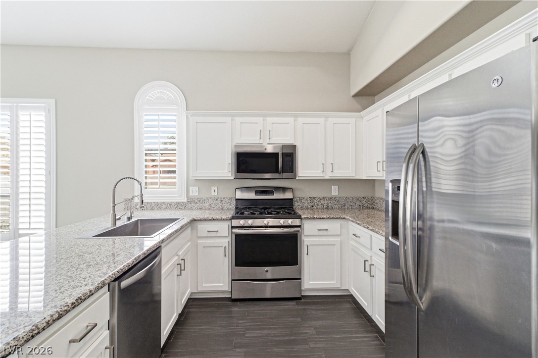 9523 Observer Street Las Vegas, NV 89123 - Photo 11 of 42 Culinary creations come to life in this kitchen, featuring ample counter space and modern appliances.