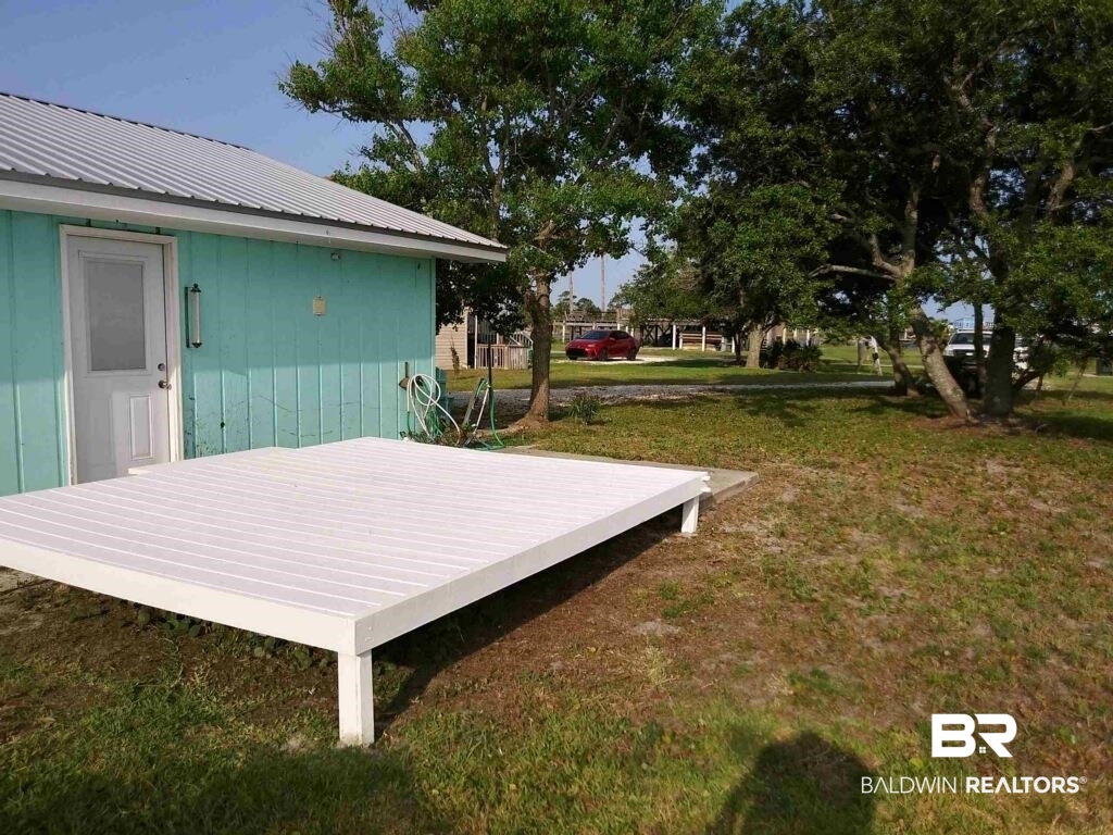 2412 Choctaw Road Gulf Shores, AL 36542 - Photo 14 of 16 Wooden terrace featuring a lawn