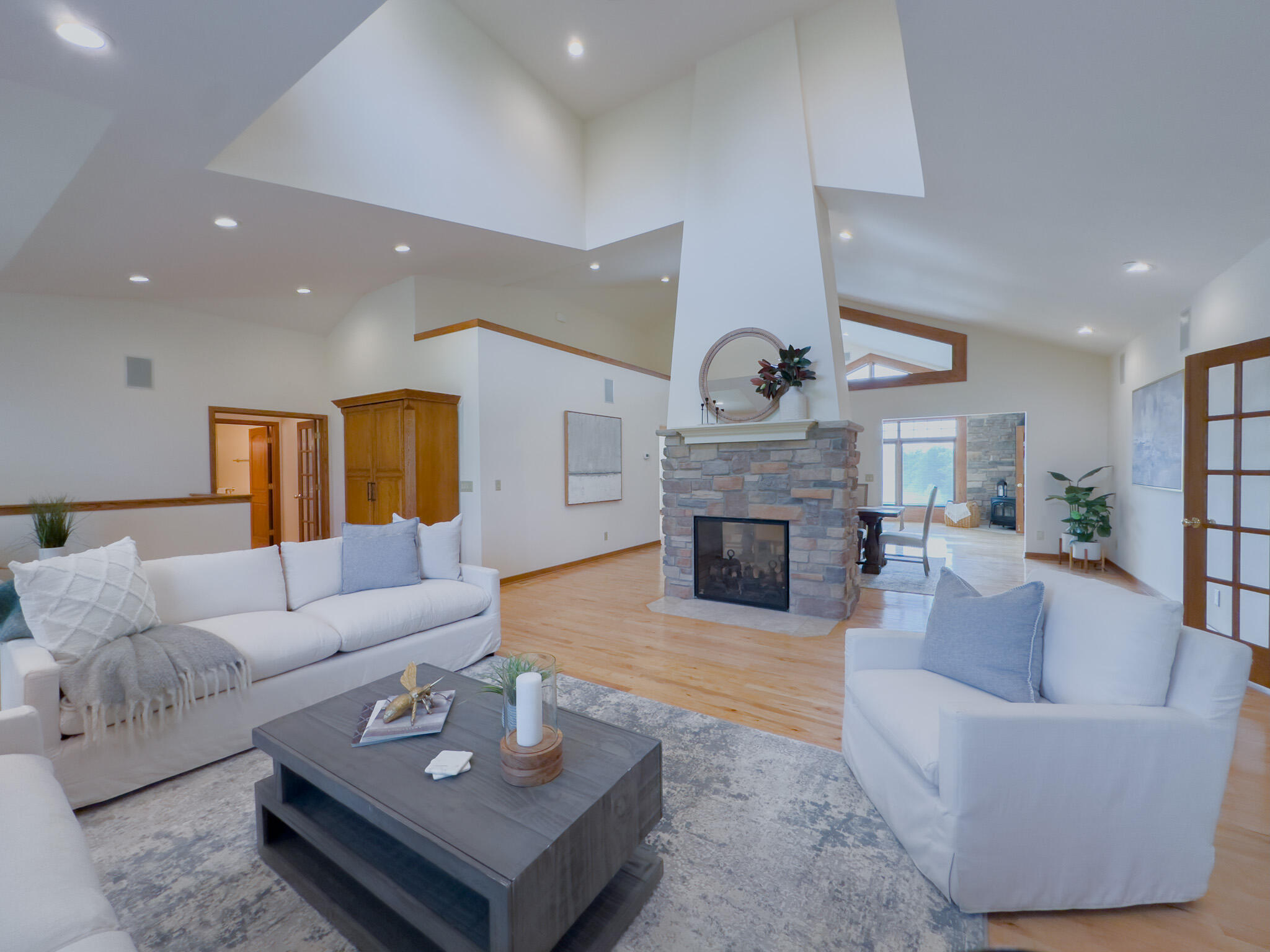 11604 North Granville Road Mequon, WI 53097 - Photo 11 of 49 Vaulted ceiling, hardwood floors and 2 sided fireplace.