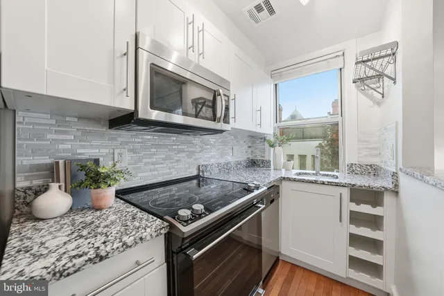 a kitchen with a stove microwave and cabinets