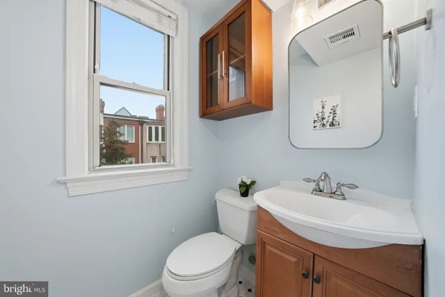 a bathroom with a toilet sink and mirror