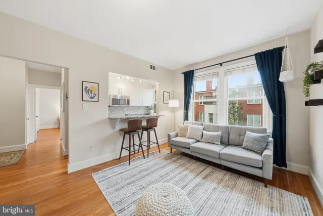 a living room with furniture and a large window
