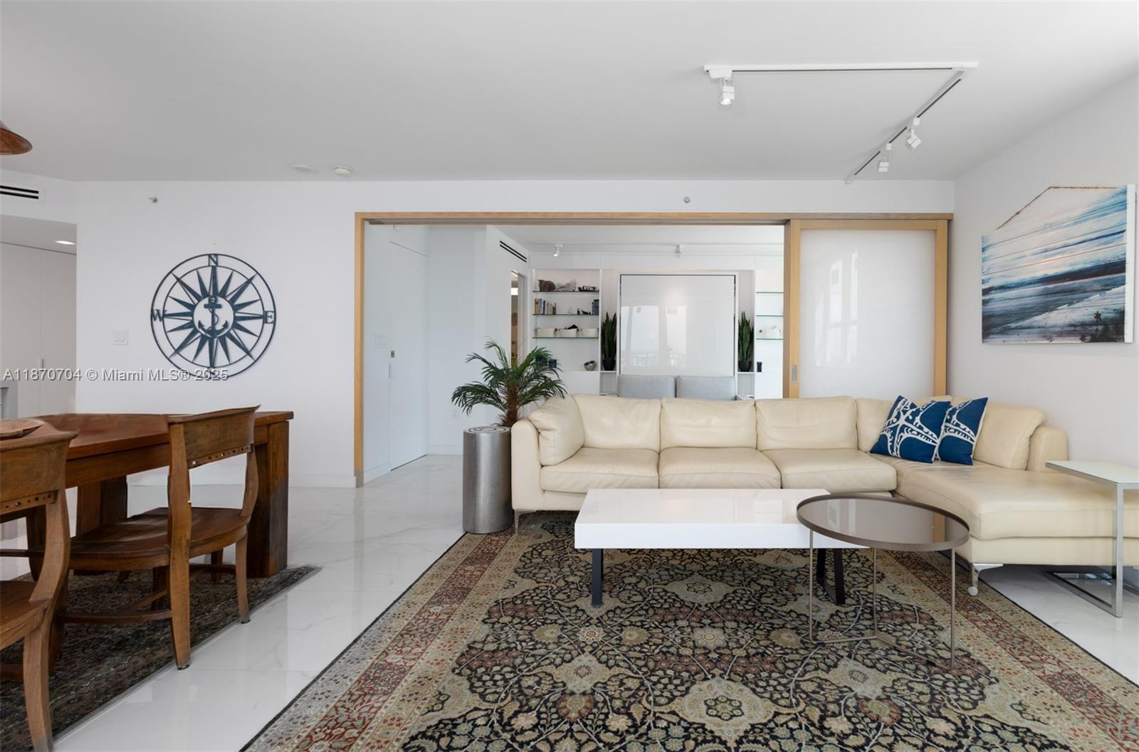 90 Alton Road, Unit 1702 Miami Beach, FL 33139 - Photo 14 of 49 a living room with furniture and a rug
