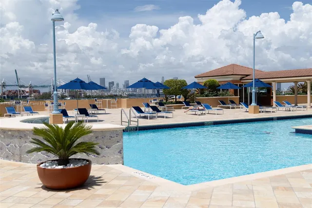 a swimming pool with outdoor seating yard and barbeque oven