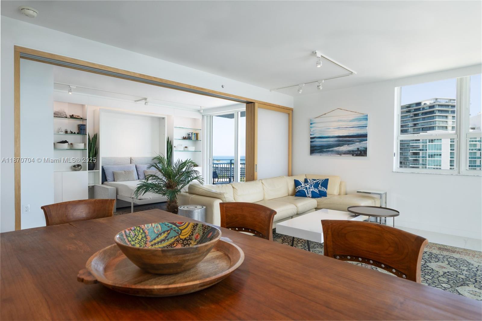 90 Alton Road, Unit 1702 Miami Beach, FL 33139 - Photo 5 of 49 a living room with furniture and a large window