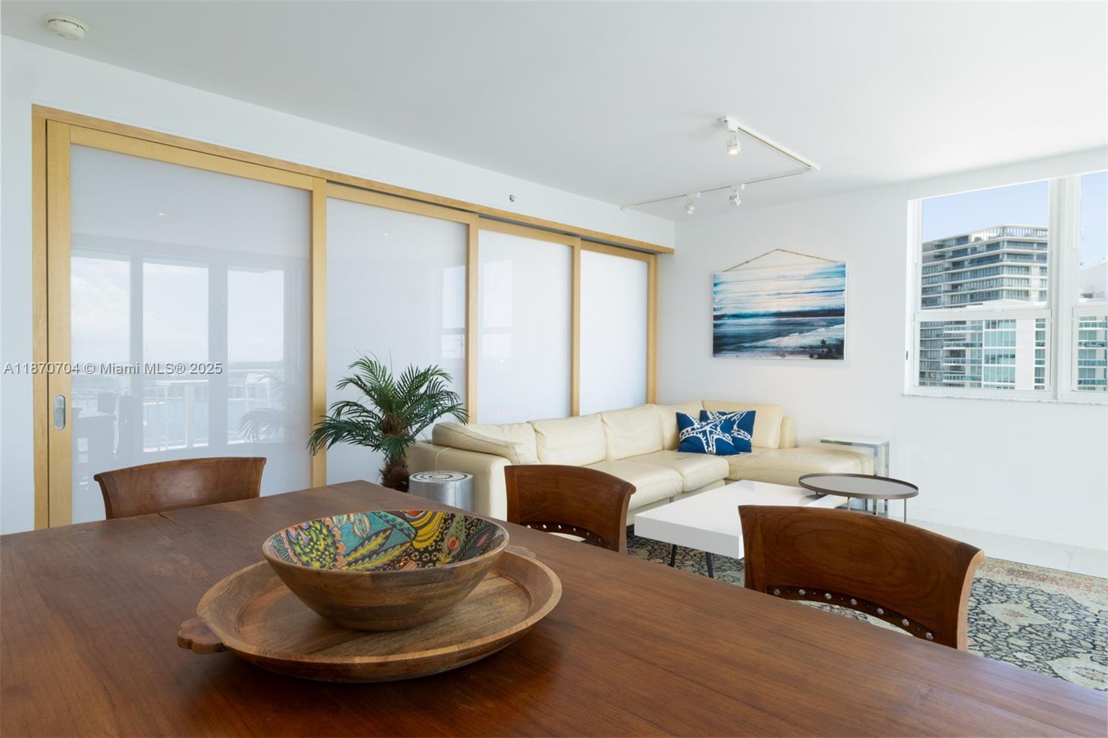 90 Alton Road, Unit 1702 Miami Beach, FL 33139 - Photo 6 of 49 a living room with furniture and a potted plant