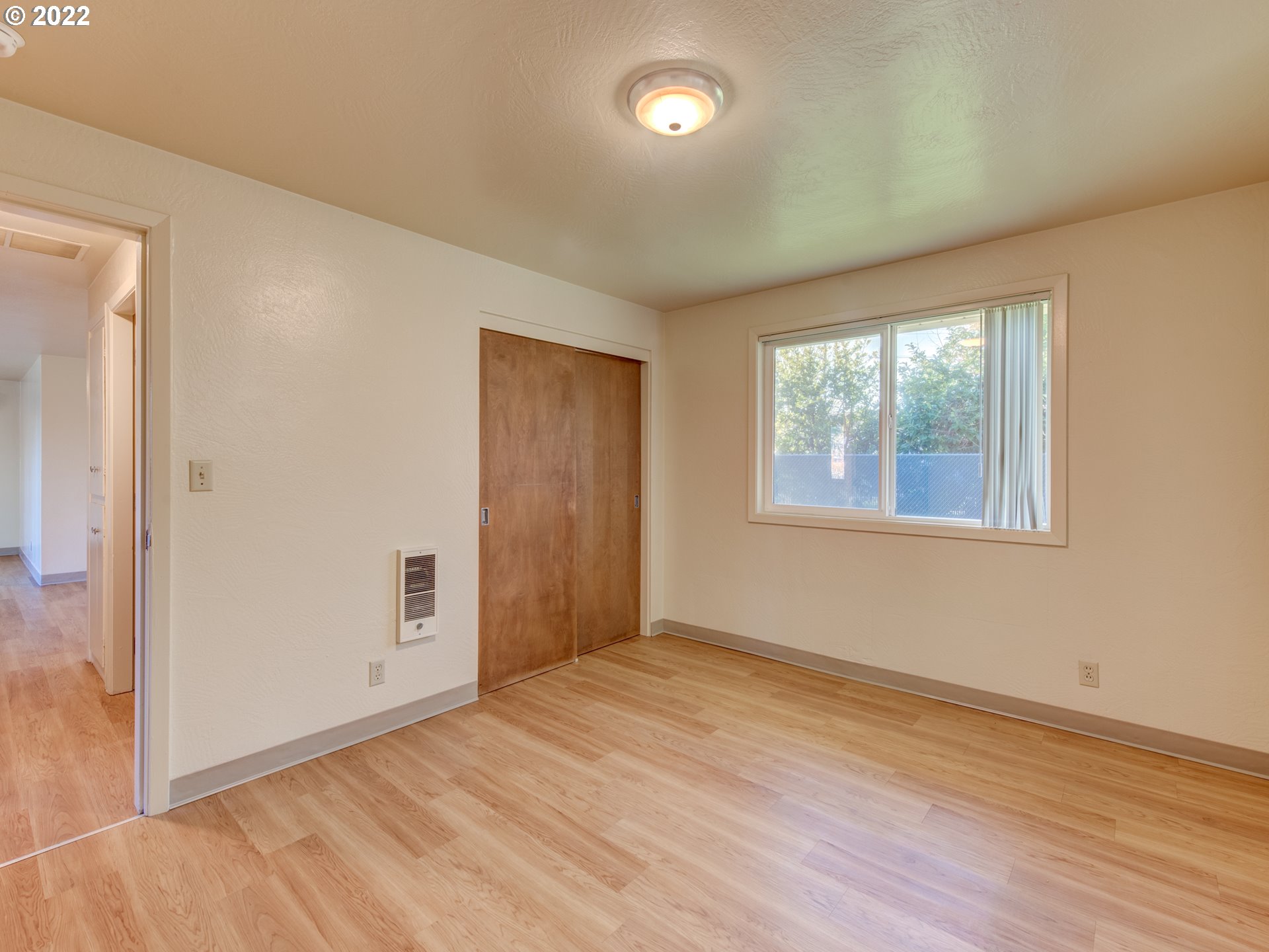 2332 Shadylane Drive Springfield, OR 97477 - Photo 18 of 27 an empty room with wooden floor and windows