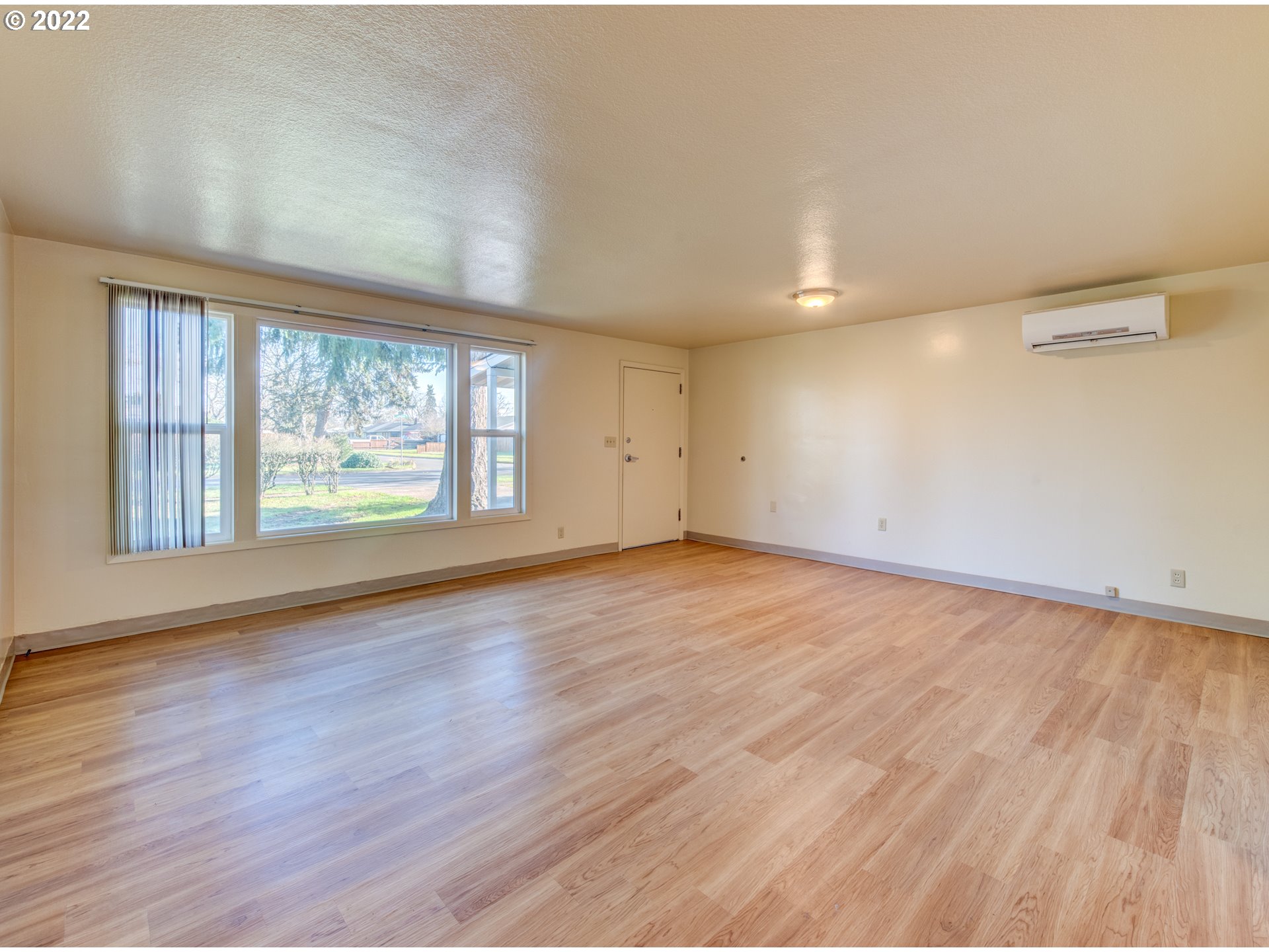 2332 Shadylane Drive Springfield, OR 97477 - Photo 6 of 27 an empty room with wooden floor and windows