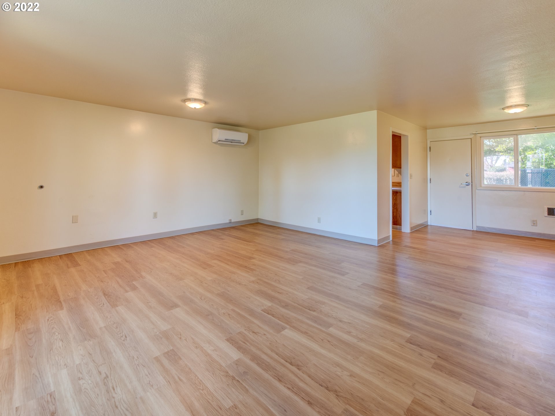 2332 Shadylane Drive Springfield, OR 97477 - Photo 7 of 27 an empty room with wooden floor and windows