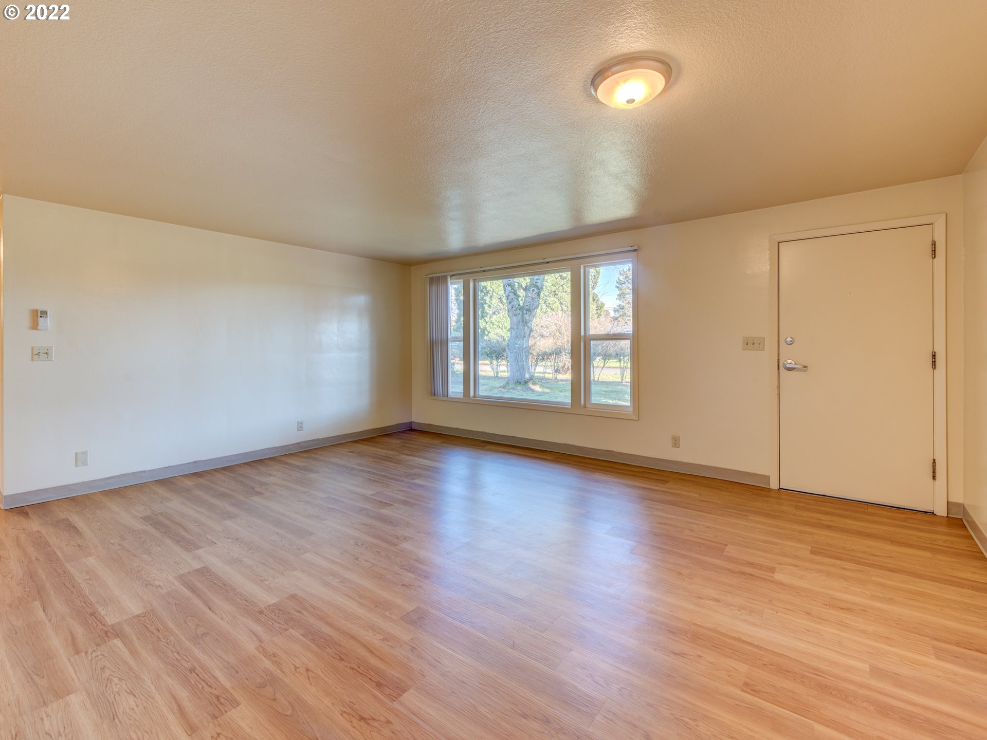 2332 Shadylane Drive Springfield, OR 97477 - Photo 9 of 27 an empty room with wooden floor and windows