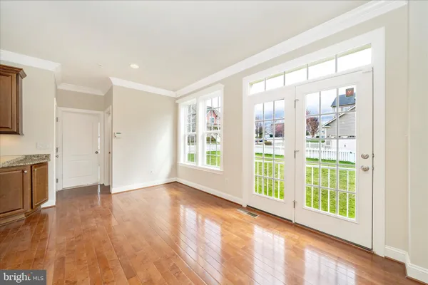 an empty room with a ceiling fan and a window