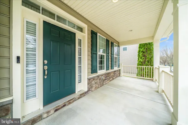 a view of an entryway with wooden floor and windows