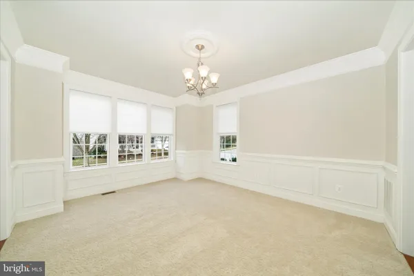 a kitchen with stainless steel appliances granite countertop a refrigerator a sink dishwasher a stove and white countertops with wooden floor