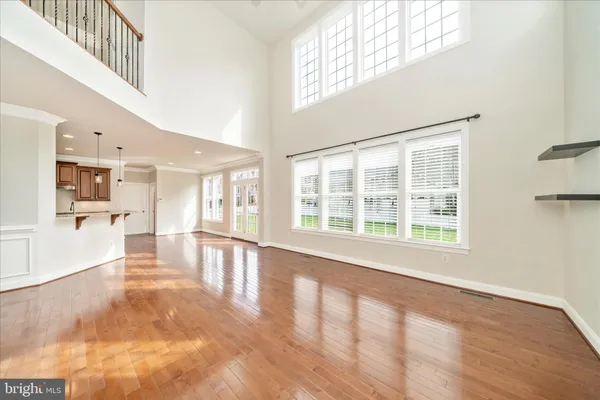 a kitchen with stainless steel appliances granite countertop wooden floor sink stove and a granite counter top