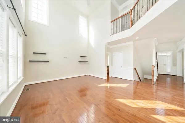 a kitchen with stainless steel appliances granite countertop a stove top oven a sink and dishwasher with wooden floor