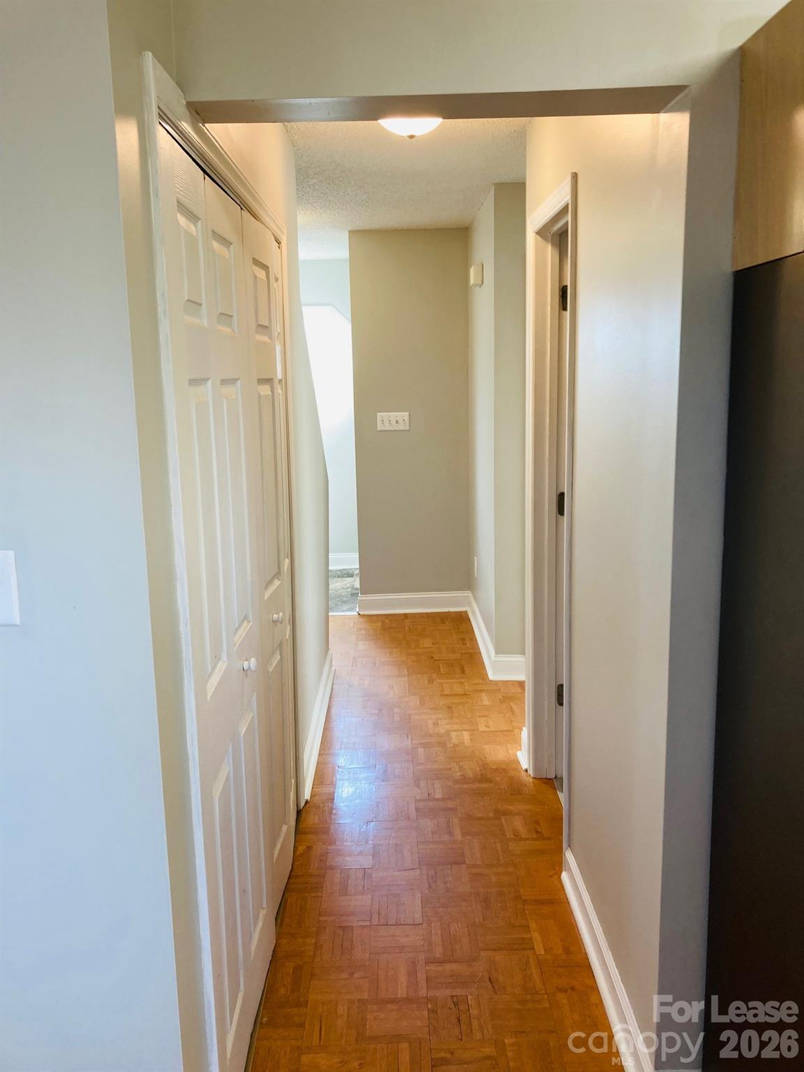 7781 Red Robin Trail Denver, NC 28037 - Photo 11 of 26 a view of a hallway with wooden floor and glass doors