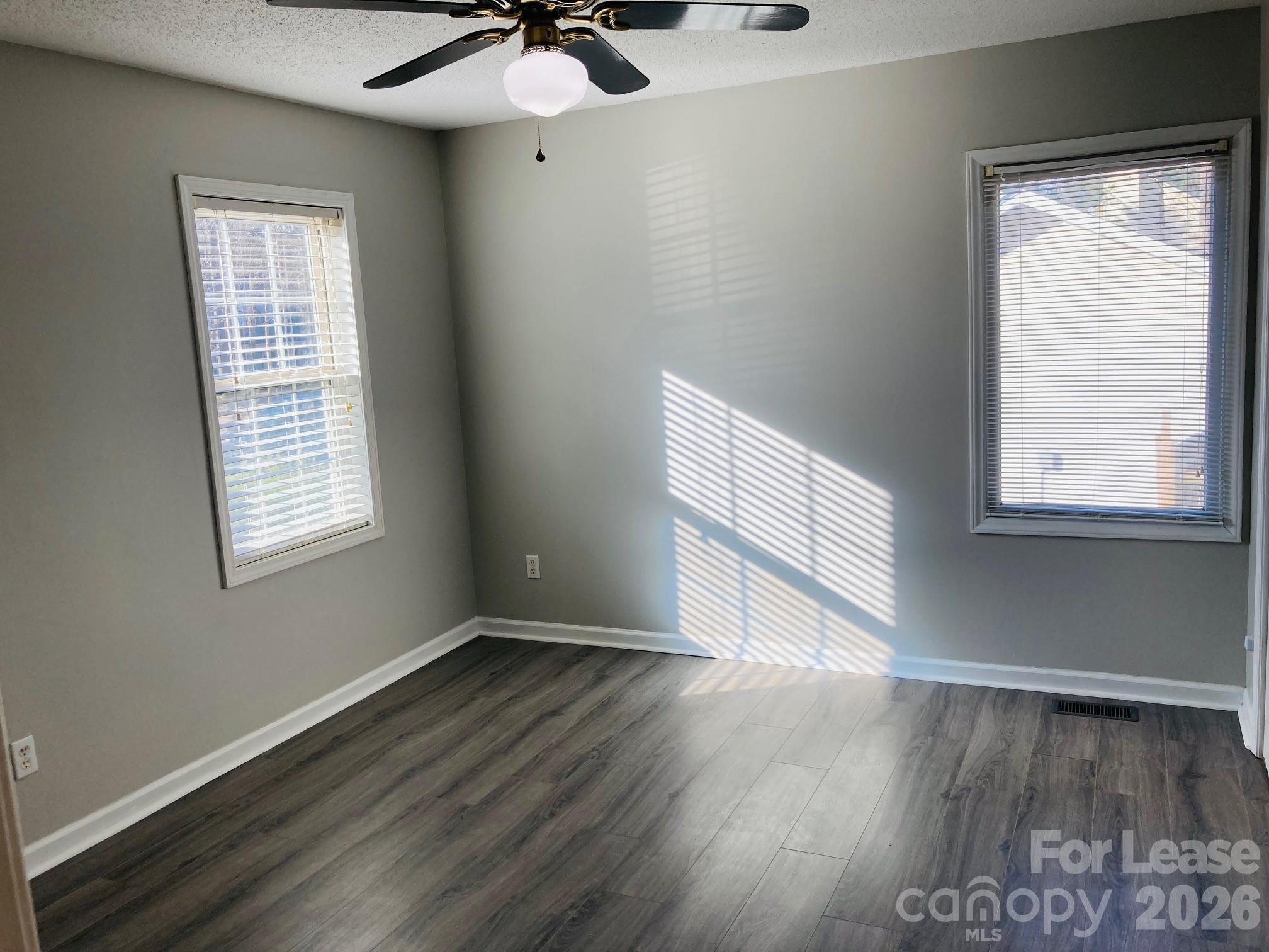 7781 Red Robin Trail Denver, NC 28037 - Photo 13 of 26 a view of an empty room with wooden floor and a window