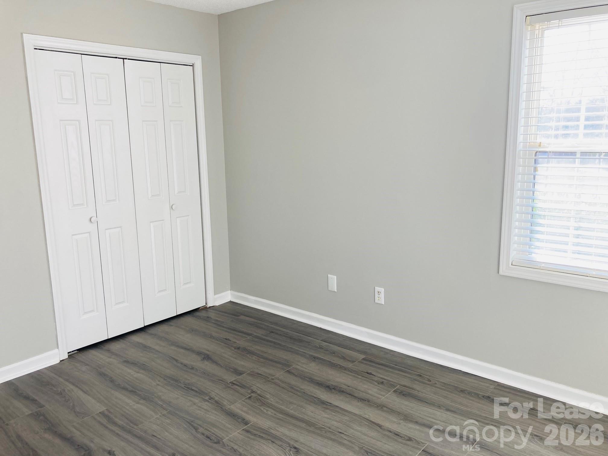 7781 Red Robin Trail Denver, NC 28037 - Photo 15 of 26 a view of an empty room with wooden floor and a window