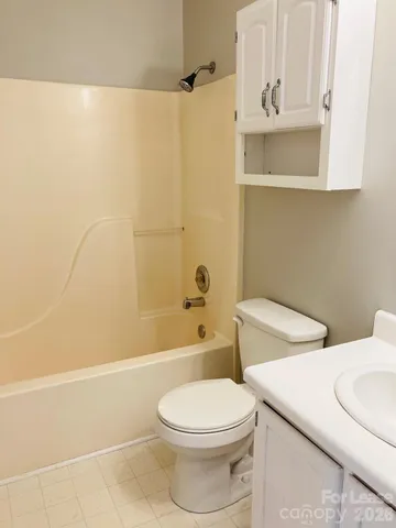 a bathroom with a toilet a sink and bathtub
