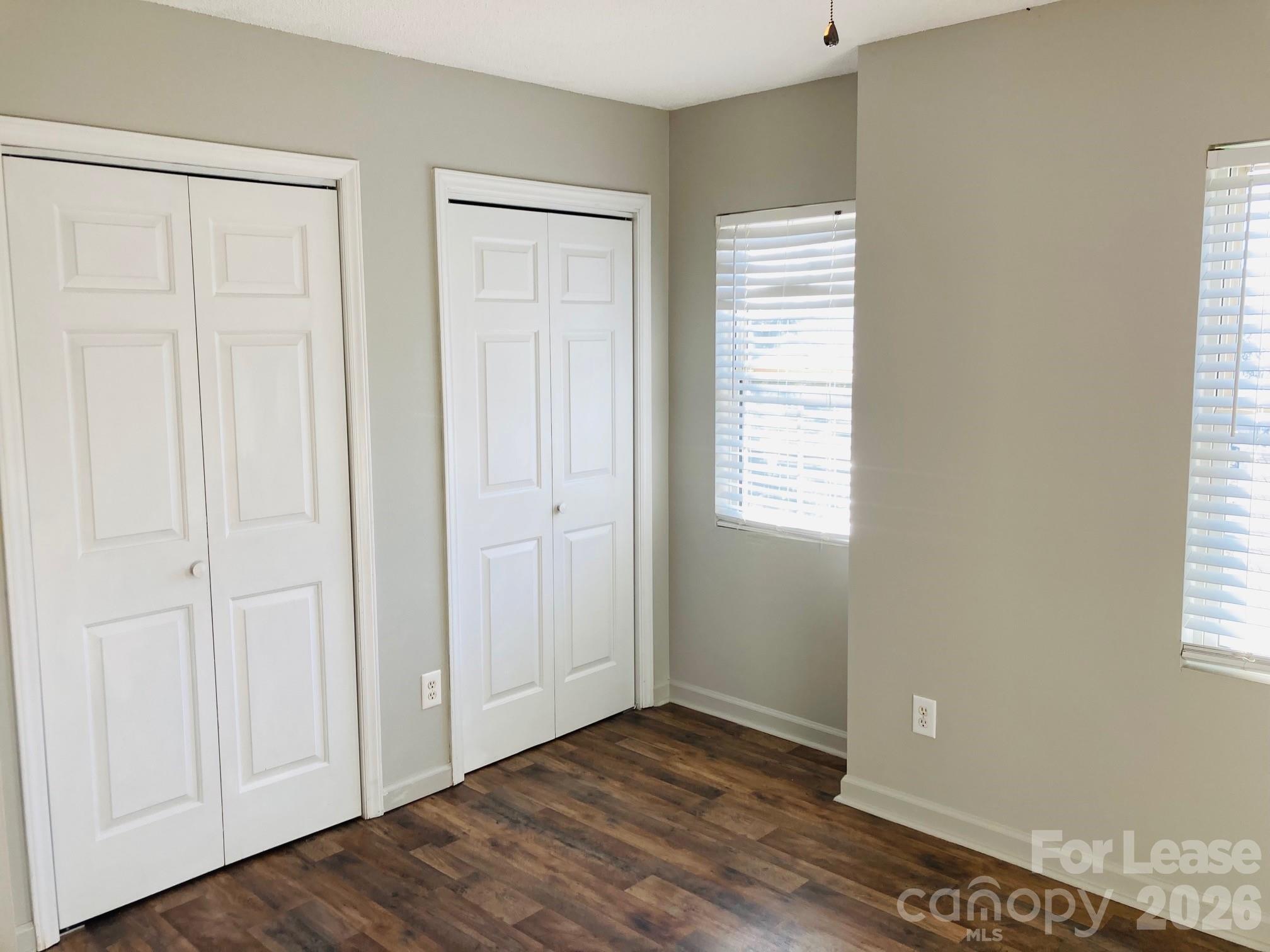 7781 Red Robin Trail Denver, NC 28037 - Photo 20 of 26 a view of an empty room with wooden floor and a window