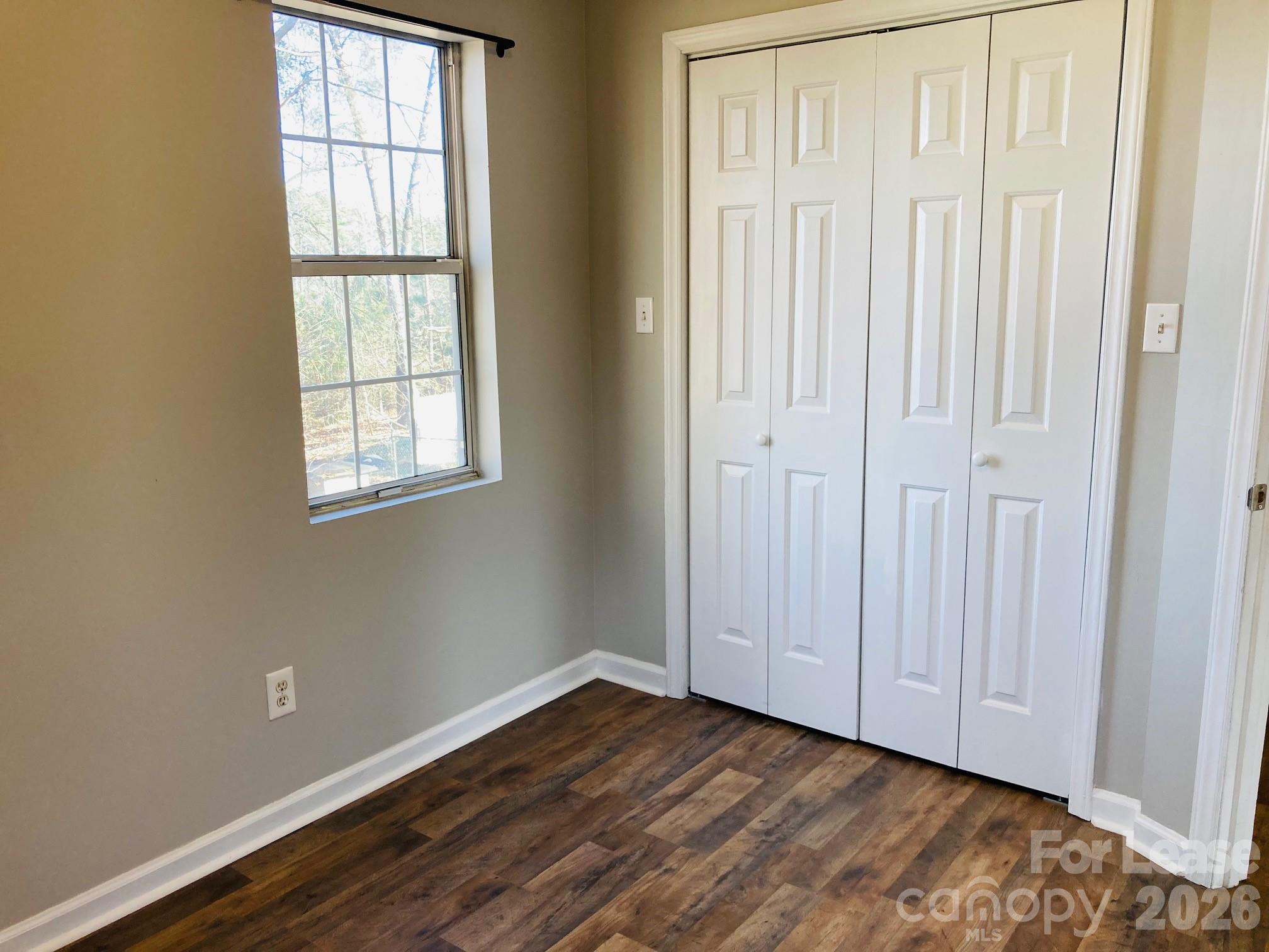 7781 Red Robin Trail Denver, NC 28037 - Photo 22 of 26 an empty room with wooden floor and windows