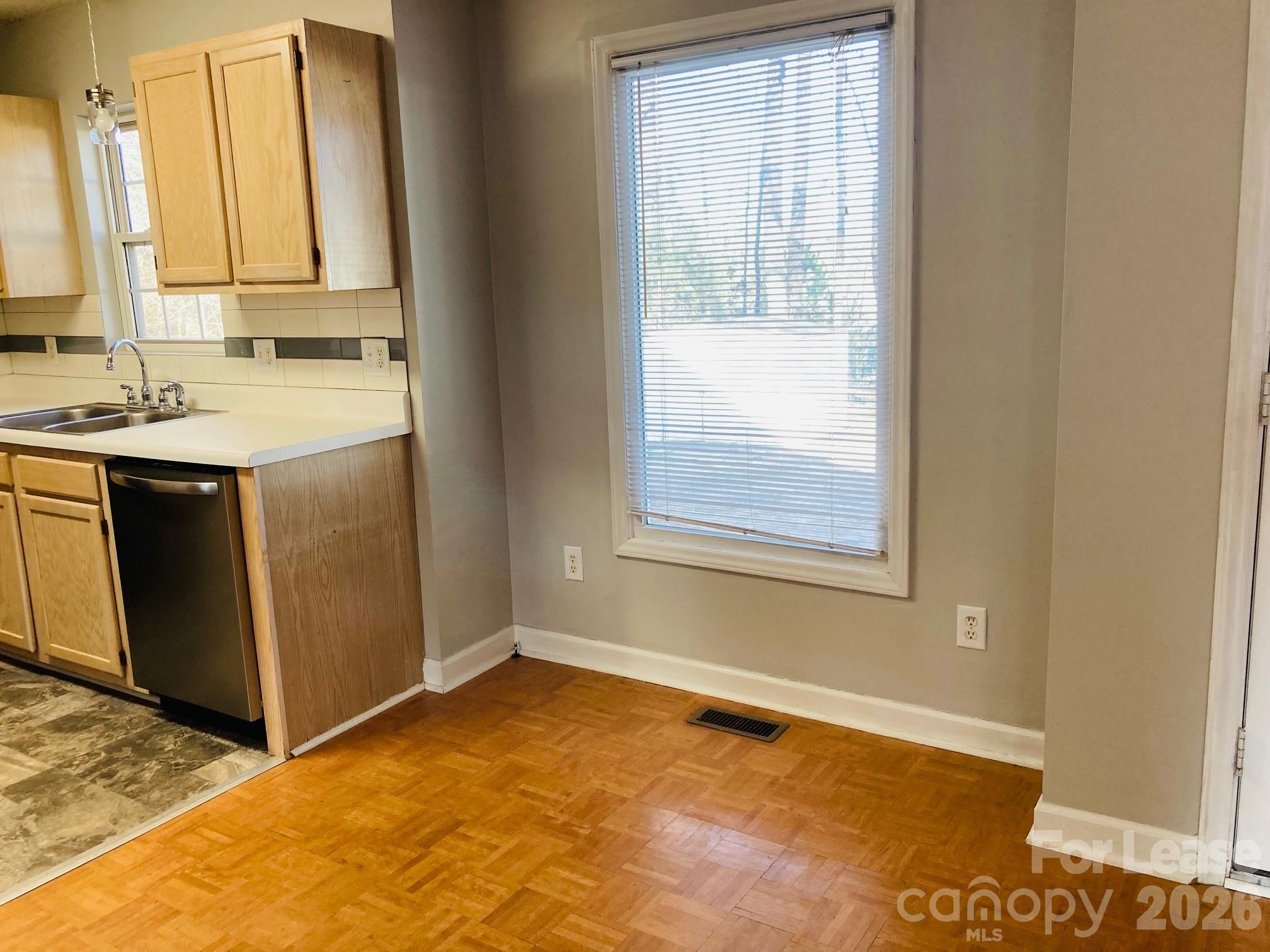 7781 Red Robin Trail Denver, NC 28037 - Photo 8 of 26 a view of a kitchen with wooden floor and a sink