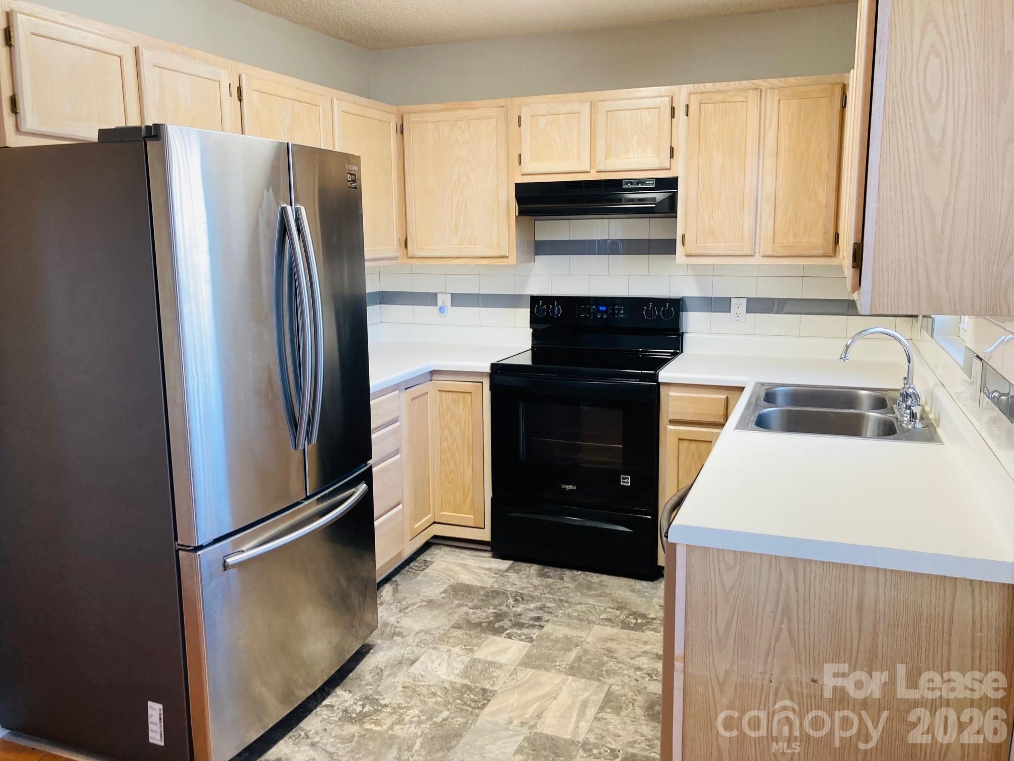 7781 Red Robin Trail Denver, NC 28037 - Photo 9 of 26 a kitchen with a refrigerator sink and cabinets
