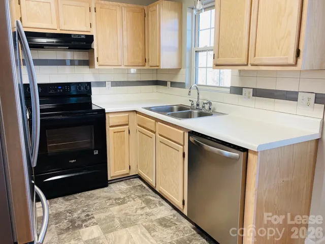 a kitchen with a stove and a sink