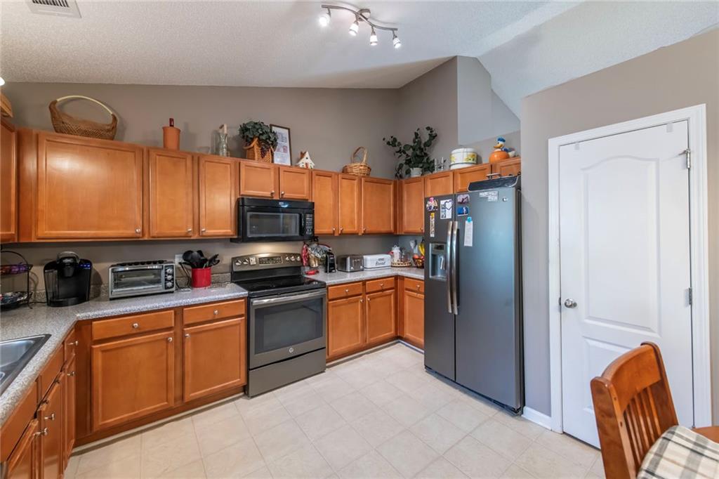 170 Baskin Road Temple, GA 30179 - Photo 12 of 34 a kitchen with stainless steel appliances granite countertop a refrigerator and a sink