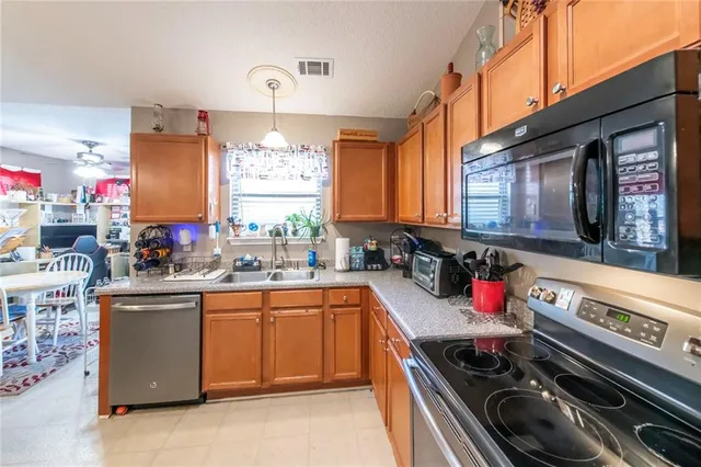 a kitchen that has a sink and a stove
