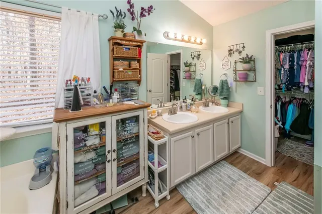 a bathroom with a double vanity sink and a mirror