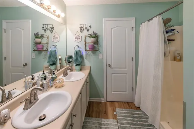 a bathroom with a sink a mirror and a shower