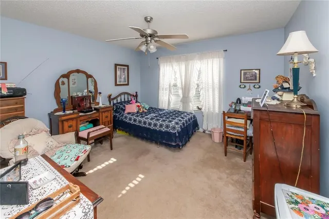a bedroom with bed and a chandelier