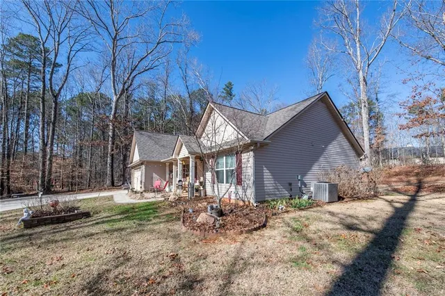 a view of house with a yard