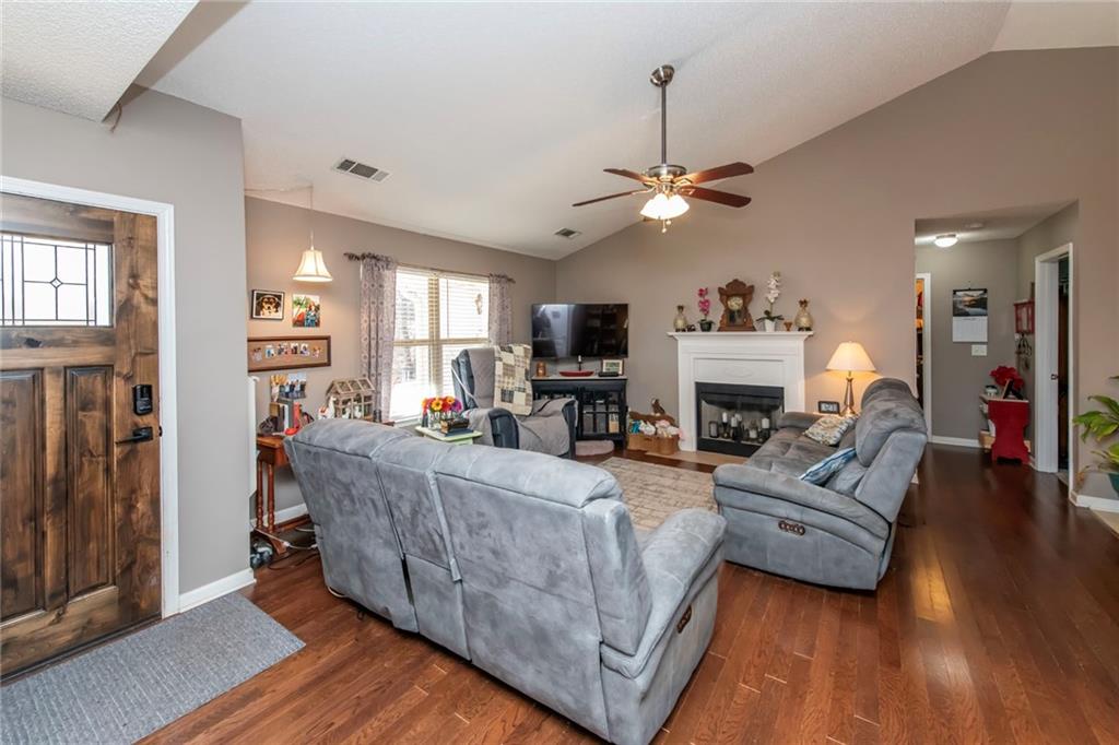 170 Baskin Road Temple, GA 30179 - Photo 6 of 34 a living room with furniture a fireplace and a chandelier