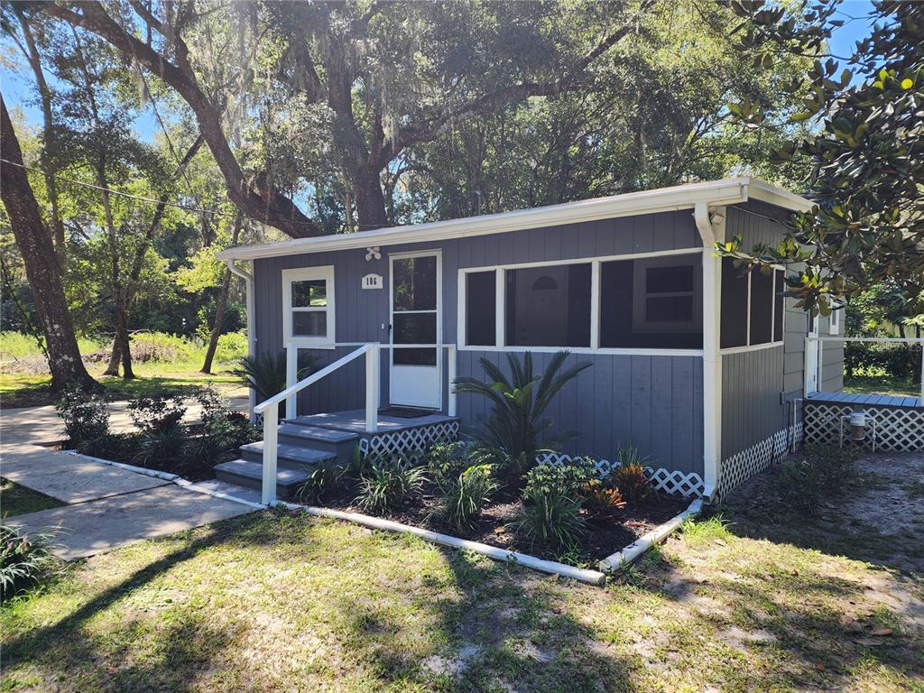 106 Southwest 6th Street Micanopy, FL 32667 - Photo 2 of 62 a view of a house with backyard and sitting area