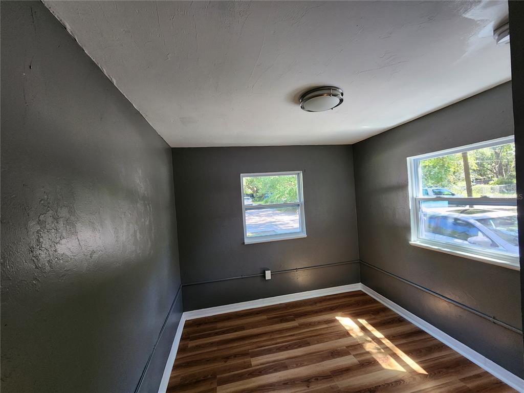 106 Southwest 6th Street Micanopy, FL 32667 - Photo 22 of 62 a view of an empty room with wooden floor and a window