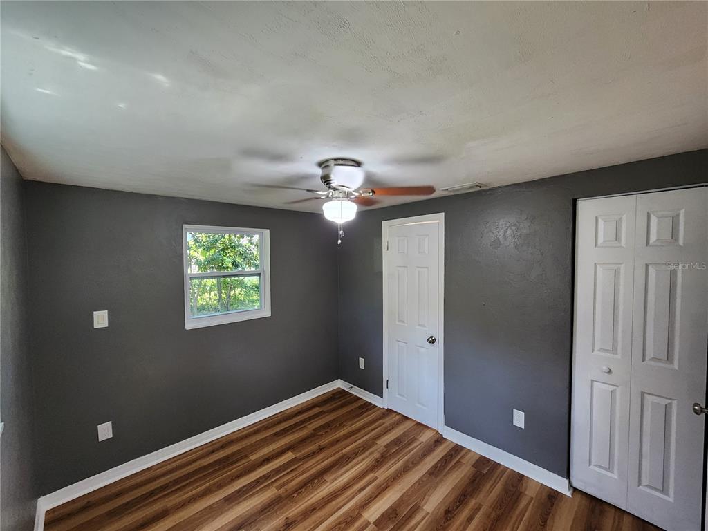 106 Southwest 6th Street Micanopy, FL 32667 - Photo 26 of 62 a view of empty room with window and ceiling fan
